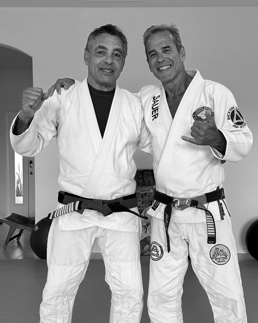 Two students training and smiling on the mat