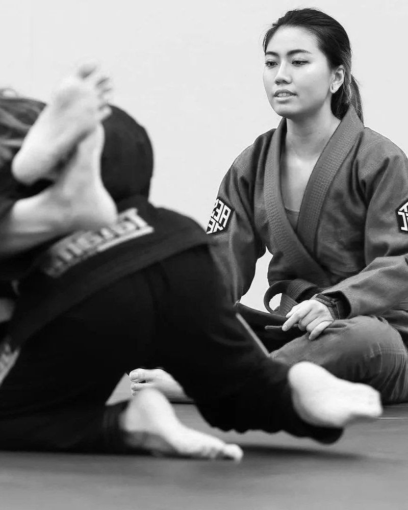 Two women training jiu-jitsu together